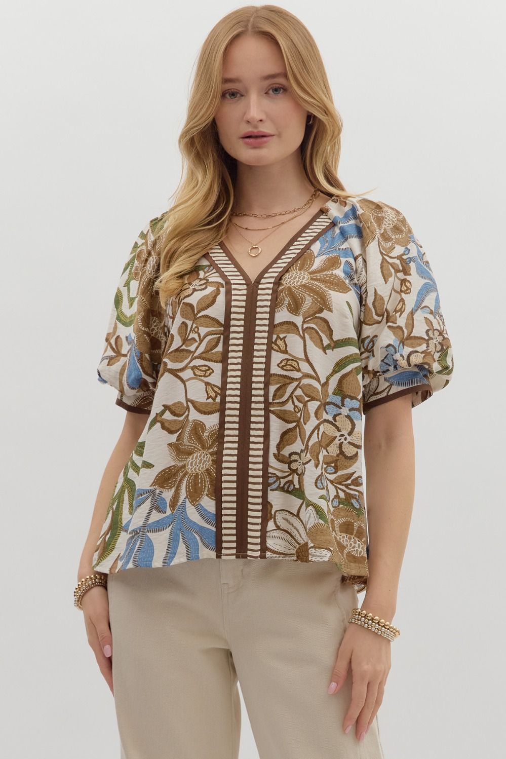 Botanical print short bubble sleeve top featuring contrast accent V-neck