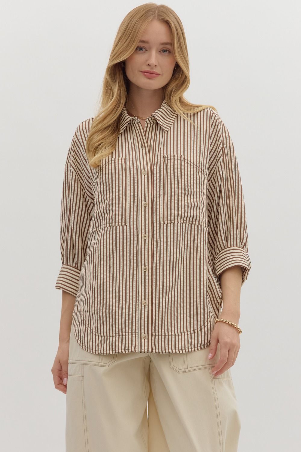 Textured stripe pattern reverse cuff ¾ sleeve shirt. Double shirt pockets at front