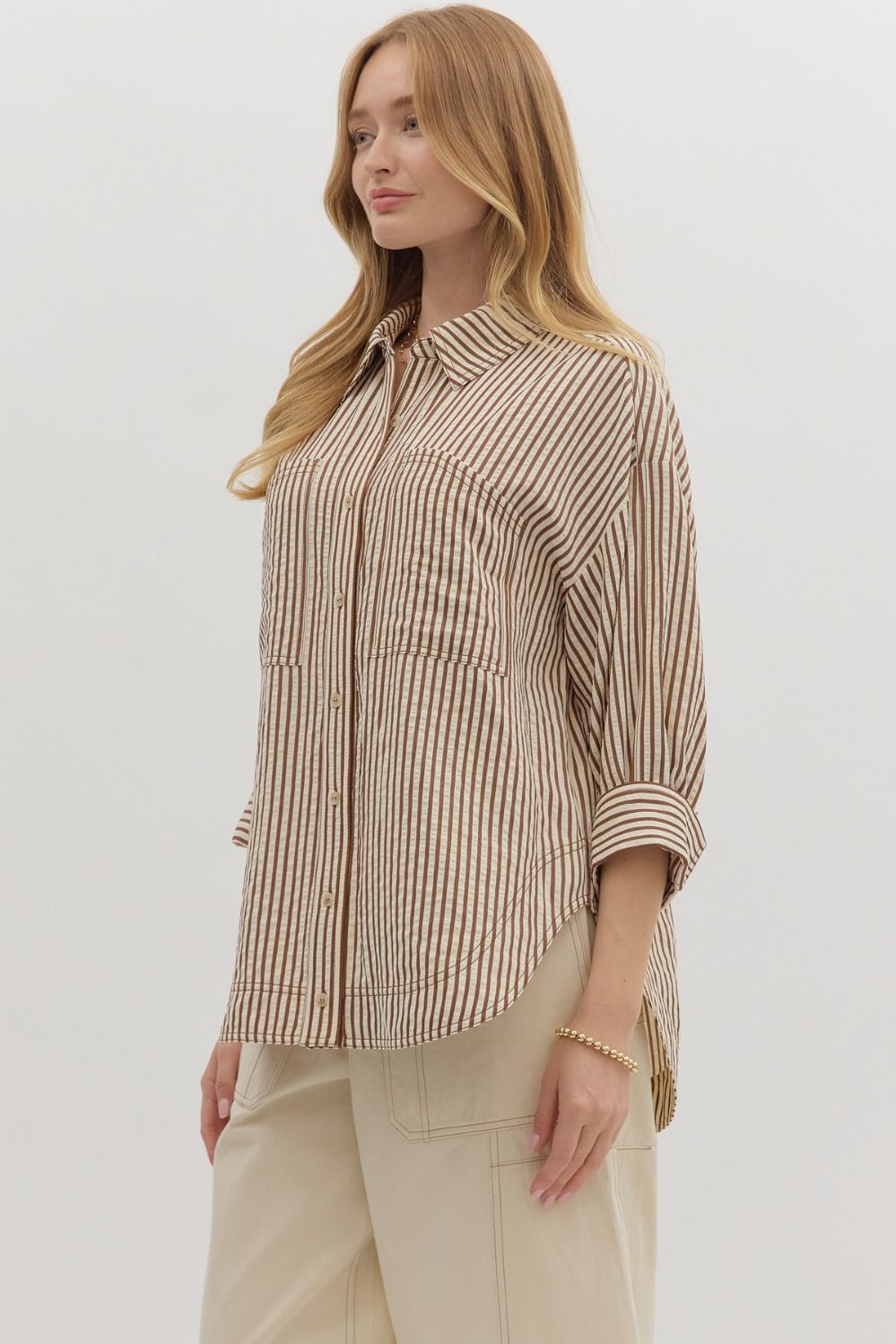 Textured stripe pattern reverse cuff ¾ sleeve shirt. Double shirt pockets at front