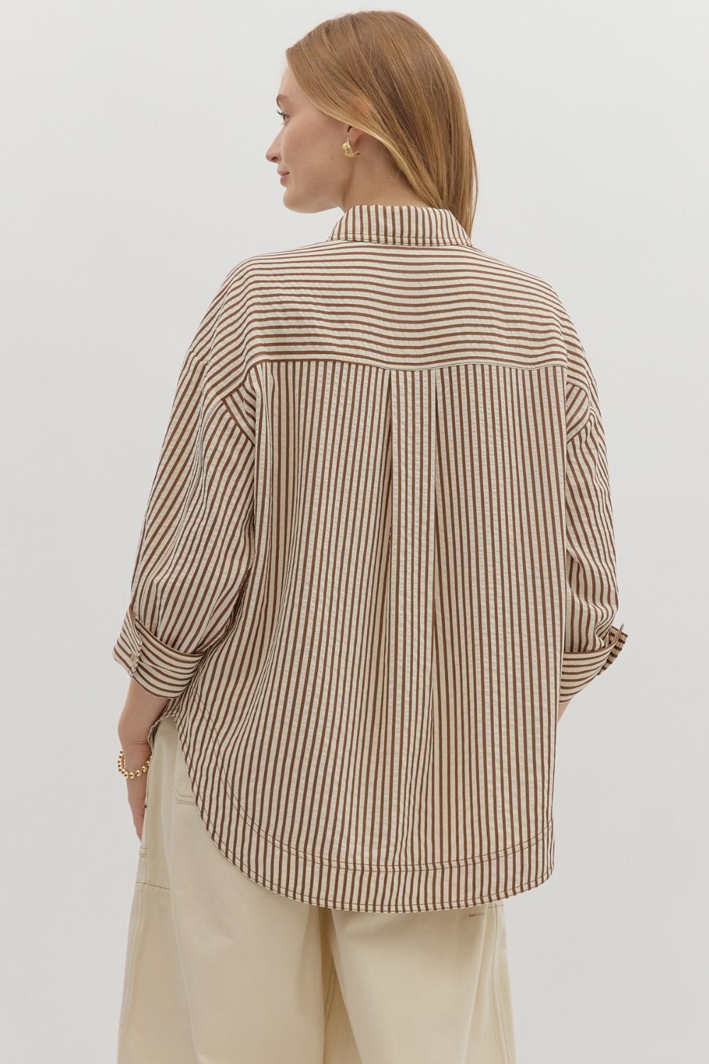 Textured stripe pattern reverse cuff ¾ sleeve shirt. Double shirt pockets at front
