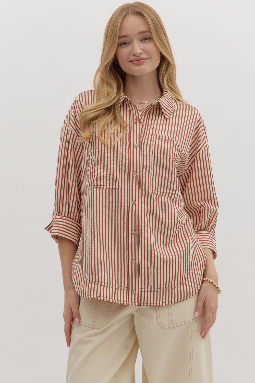 Textured stripe pattern reverse cuff ¾ sleeve shirt. Double shirt pockets at front