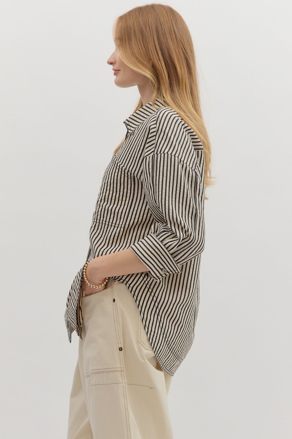 Textured stripe pattern reverse cuff ¾ sleeve shirt. Double shirt pockets at front