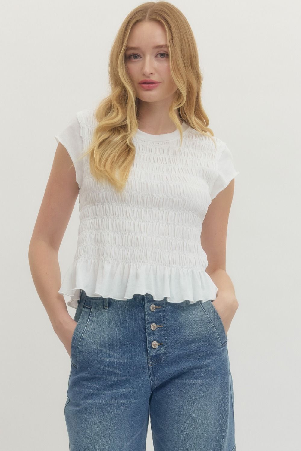 Solid short sleeve top featuring smocked