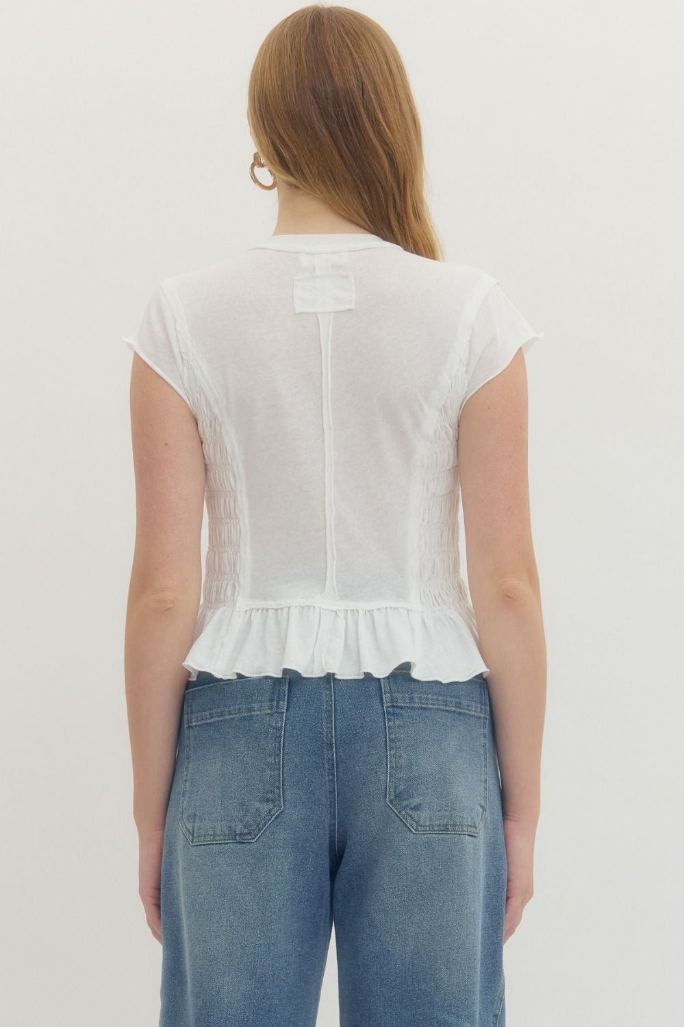 Solid short sleeve top featuring smocked