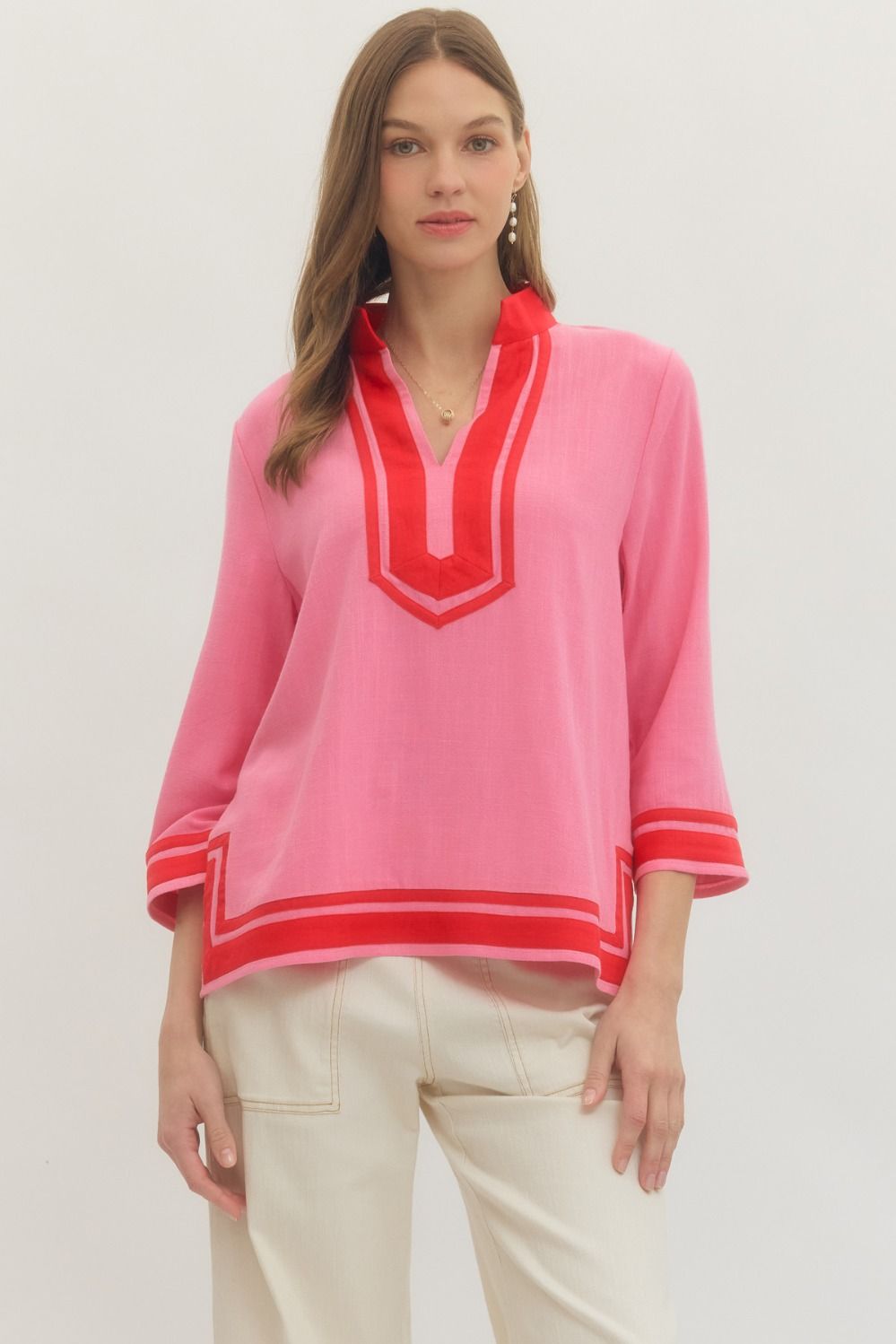 Solid 3/4 sleeve top featuring contrast trim V-neck collar