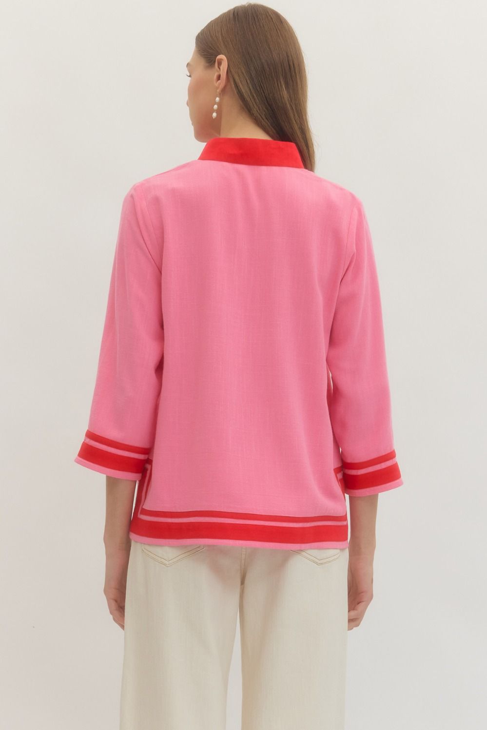 Solid 3/4 sleeve top featuring contrast trim V-neck collar