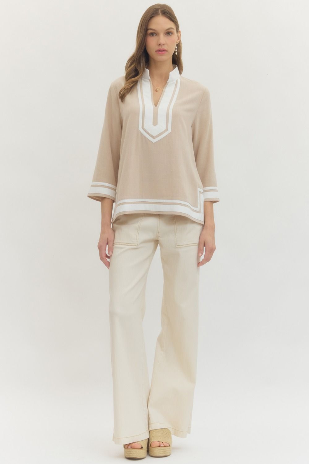 Solid 3/4 sleeve top featuring contrast trim V-neck collar